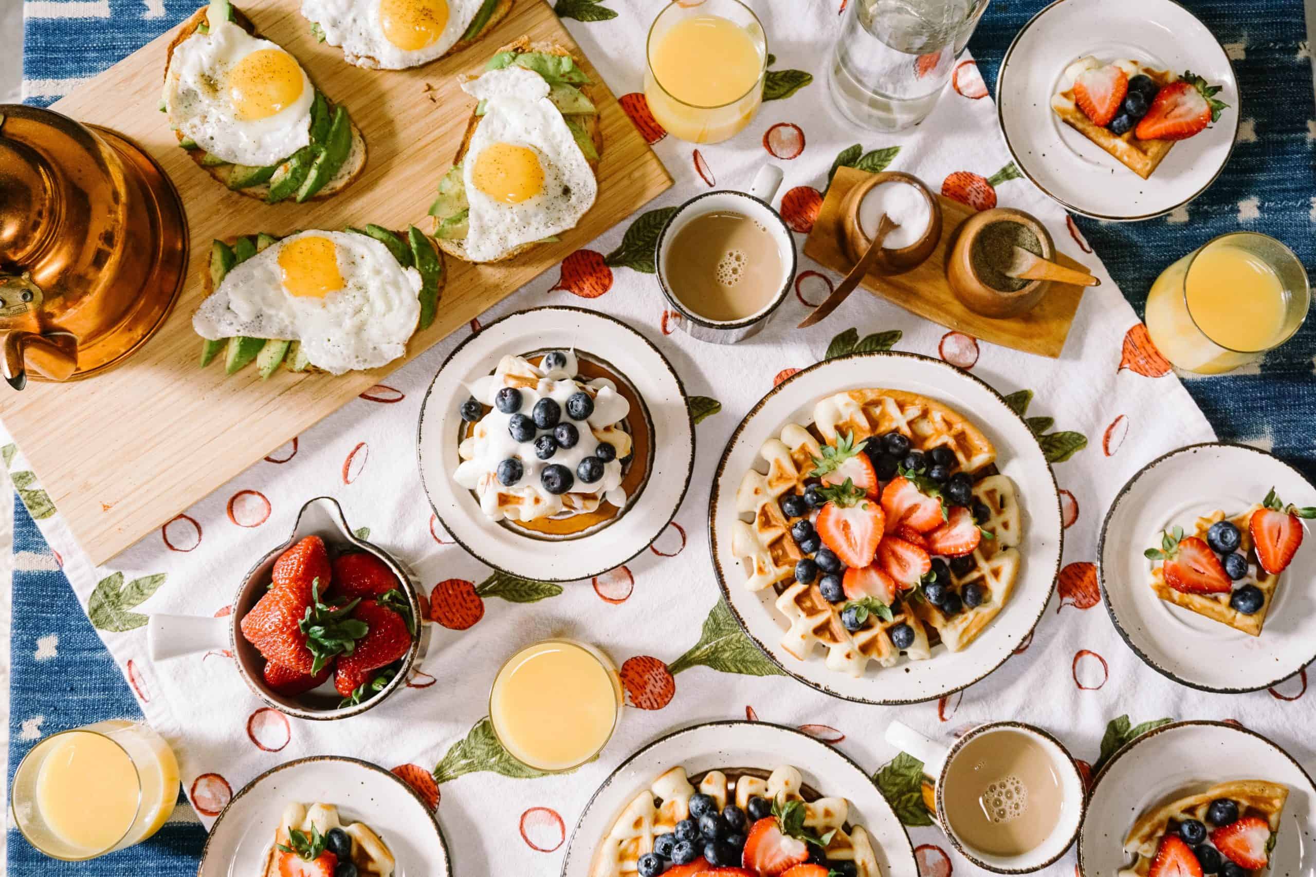 A table set with multiple breakfast food items
