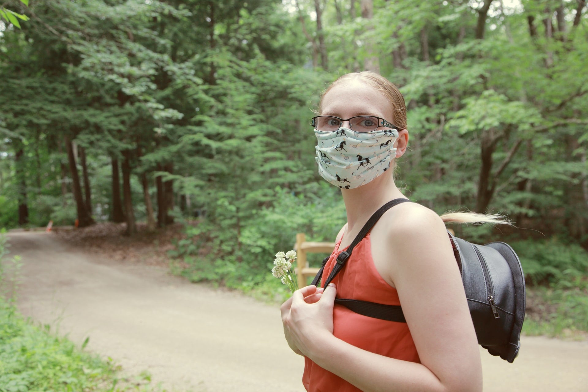 Woman wearing mask hiking