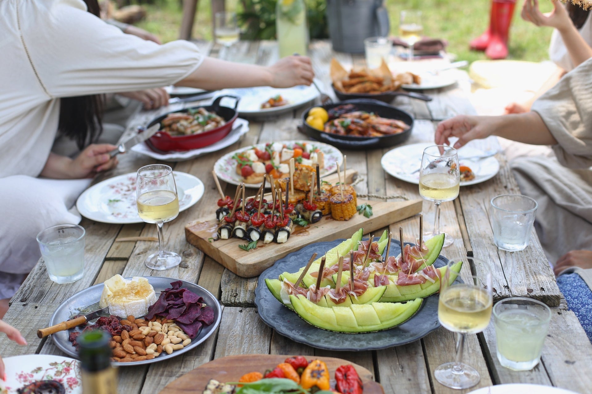 People sharing a large meal at an outdoor table