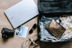 Open suitcase packed with items for travel