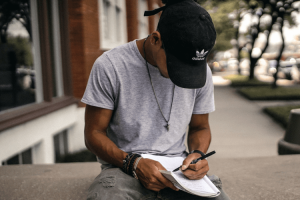 Man sitting outside and writing