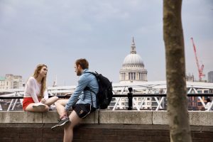 Couple sitting and chatting in front of Capitol Building in Washington, D.C.