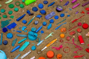 A rainbow collection of litter in the sand