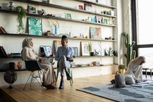 Two Black women sitting at a table talking